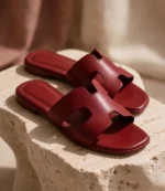 Close-up of maroon leather-look H cutout slides with cushioned footbed