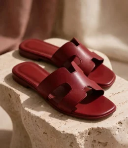 Close-up of maroon leather-look H cutout slides with cushioned footbed