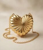 Golden heart shaped clutch with scalloped sunburst design and gold chain strap