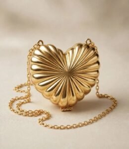 Golden heart shaped clutch with scalloped sunburst design and gold chain strap